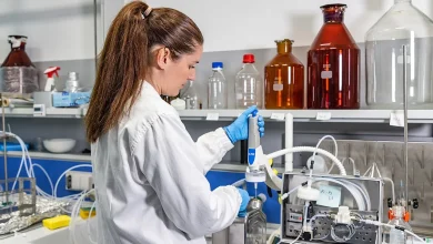 Scientists working in a water analysis laboratory with sample bottles