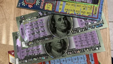 Hands holding scratched lottery tickets