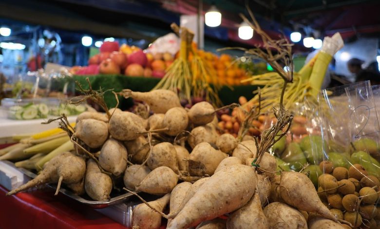 A farmers market stall with vegetables