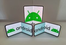 A hand holding a folding smartphone half open