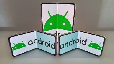 A hand holding a folding smartphone half open