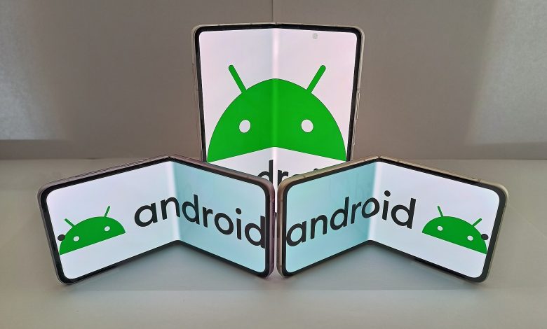 A hand holding a folding smartphone half open
